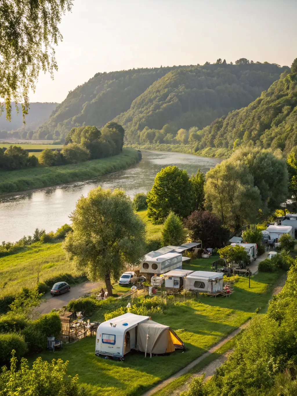 An aerial view of the Powered Sites at Southport Tourist Park, showcasing well-organized spaces with caravans and camping setups, surrounded by trees.
